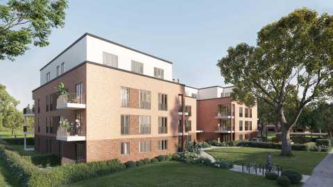 Modernes Mehrfamilienhaus mit Balkonen, umgeben von Bäumen und Grünanlage.