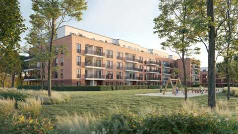 Modernes Wohnhaus mit Balkonen, grüne Wiese, Spielplatz und Bäume im Vordergrund.